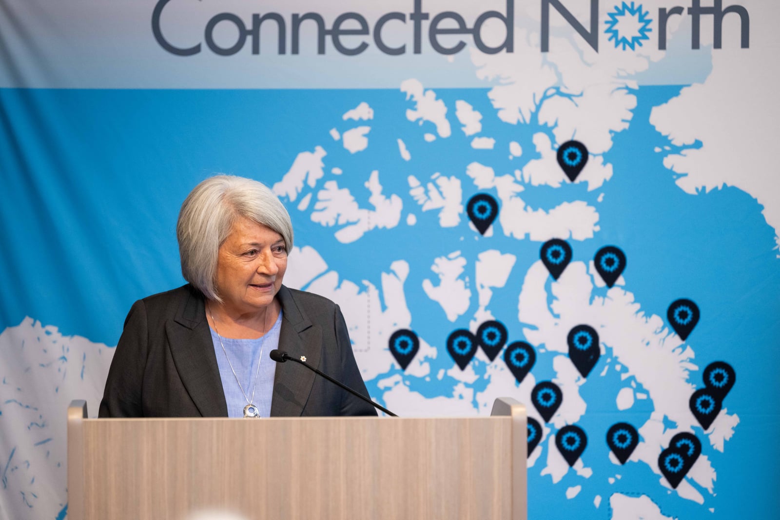 The Right Honourable Mary Simon speaking at a podium in front of a Connected North banner.